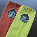 Pixel  tabi socks featuring a pixel-style train design in green and orange