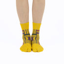 Person wearing long yellow Tabi Socks " Sankuzushi ", front view