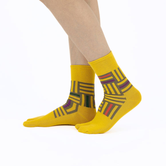 Person wearing long yellow Tabi Socks " Sankuzushi ", right side view