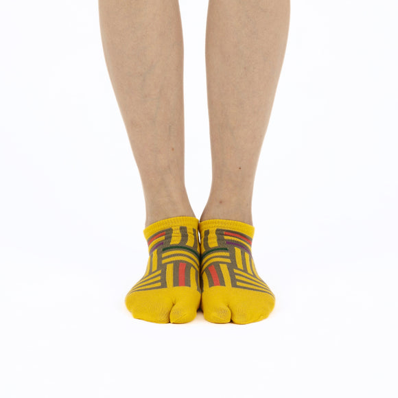 Person wearing short yellow Tabi Socks " Sankuzushi ", front view