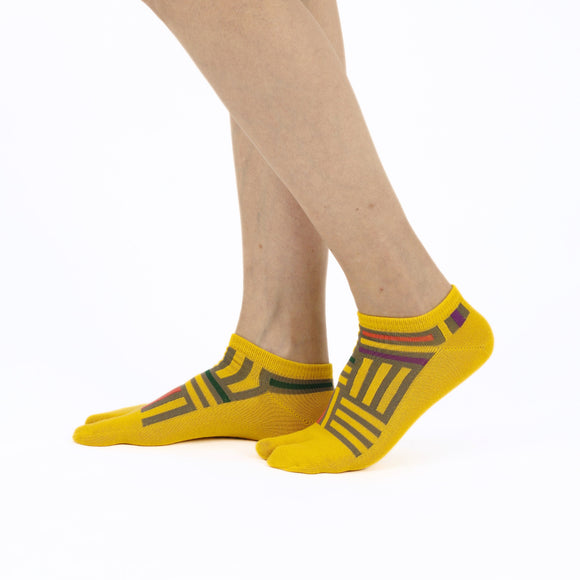 Person wearing short yellow Tabi Socks " Sankuzushi ", right side view