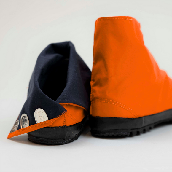 Close-up of the clasp detail (kohaze) on orange Tabi Shoes "U-ten"