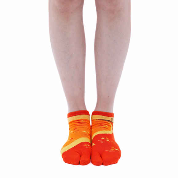 Person wearing short orange Tabi Socks " Enoshim ", front view