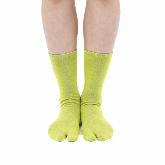 Person wearing long green Tabi Socks " Pixel Daibutsu ", front view