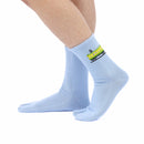 Person wearing long blue Tabi Socks " Pixel Densha ", right side view