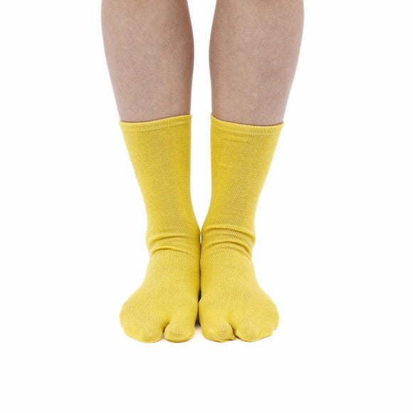 Person wearing long yellow Tabi Socks " Pixel Densha ", front view