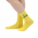 Person wearing long yellow Tabi Socks " Pixel Densha ", right side view