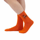 Person wearing long orange Tabi Socks " Pixel Shika ", right side view