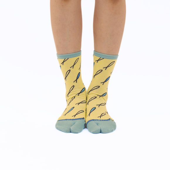 Person wearing long yellow Tabi Socks " Shirasu2", front view