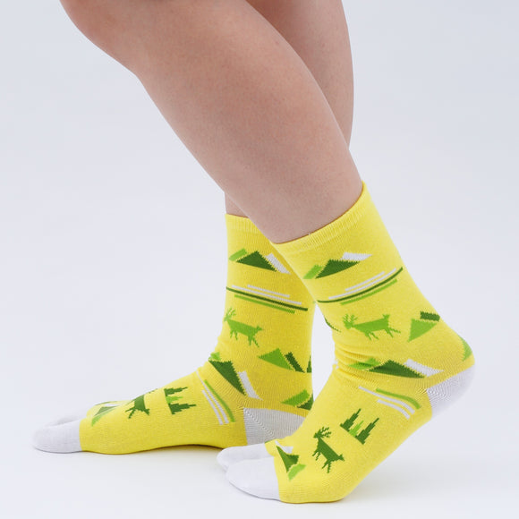 Person wearing long yellow Tabi Socks " Mikasayama ", right side view