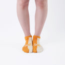Person wearing short yellow Tabi Socks " Goen ", front view