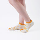 Person wearing short yellow Tabi Socks " Goen ", right side view