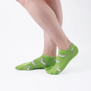 Person wearing short green Tabi Socks " Shika Hashiru ", right side view