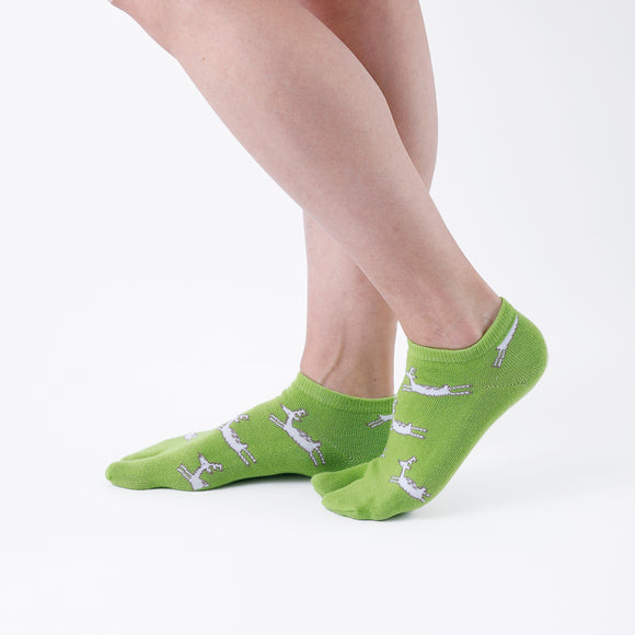 Person wearing short green Tabi Socks " Shika Hashiru ", right side view
