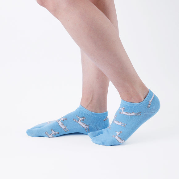 Person wearing short blue Tabi Socks " Shika Hashiru ", right side view