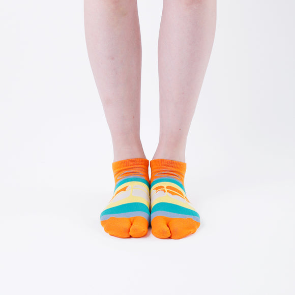 Person wearing short orange Tabi Socks " Densha ", front view