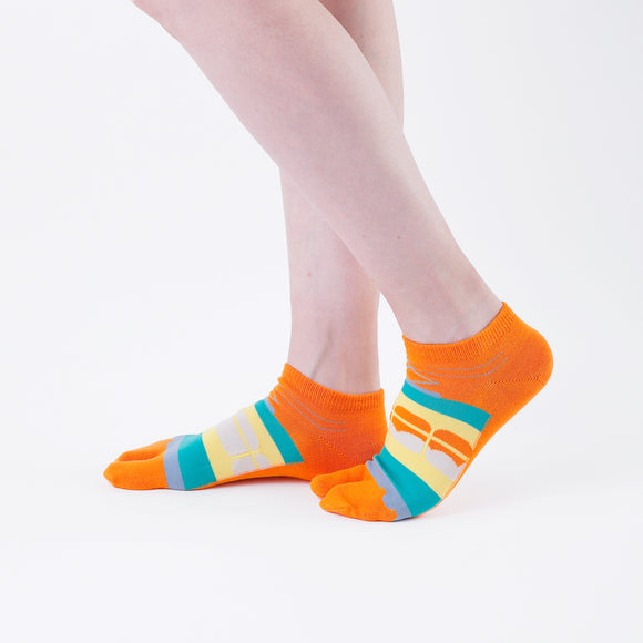 Person wearing short orange Tabi Socks " Densha ", right side view