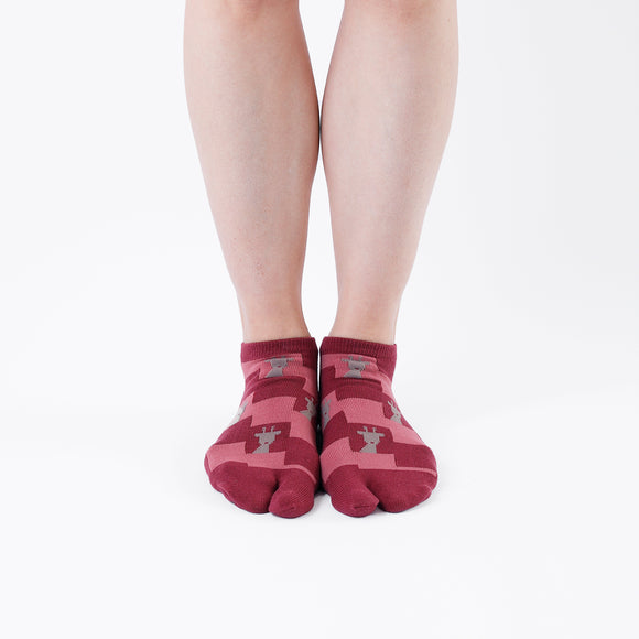 Person wearing short dark red Tabi Socks " Shika Nozoku ", front view
