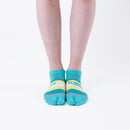 Person wearing short green Tabi Socks " Densha ", front view