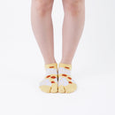 Person wearing short yellow Tabi Socks " Hato ", front view
