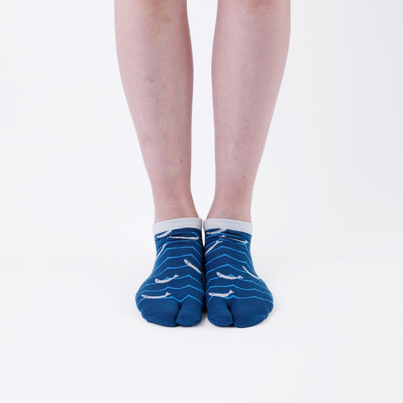 Person wearing short blue Tabi Socks " Shirasu ", front view