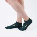 Person wearing short green Tabi Socks " Shika Nozoku ", right side view