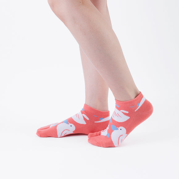 Person wearing short orange Tabi Socks " Hato ", right side view