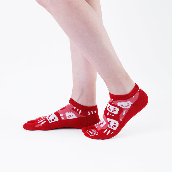 Person wearing short red Tabi Socks " Daruma ", right side view