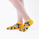 Person wearing short yellow Tabi Socks " Chigiri-e ", right side view