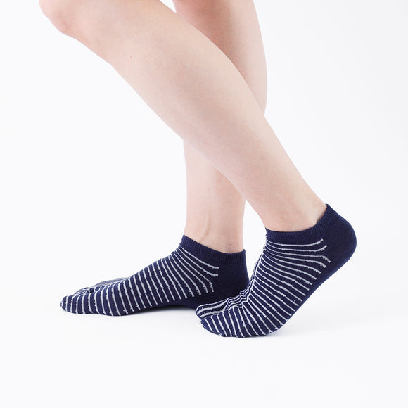 Person wearing short navy Tabi Socks " Hyoshigi ", right side view