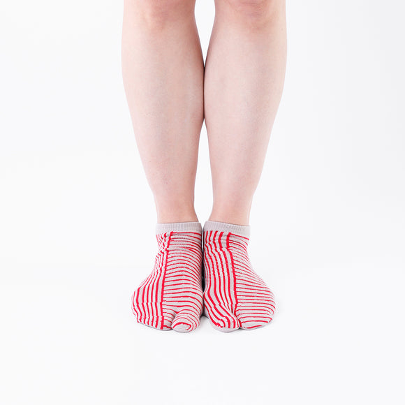 Person wearing short red Tabi Socks " Hyoshigi ", front view