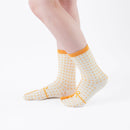 Person wearing long yellow Tabi Socks " Goen ", right side view
