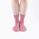 Person wearing long red Tabi Socks " Hyoshigi ", front view