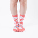 Person wearing long orange Tabi Socks " Hato ", front view