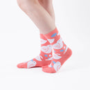 Person wearing long orange Tabi Socks " Hato ", right side view