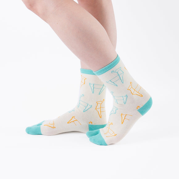 Person wearing long light yellow Tabi Socks " Shika Origami ", right side view