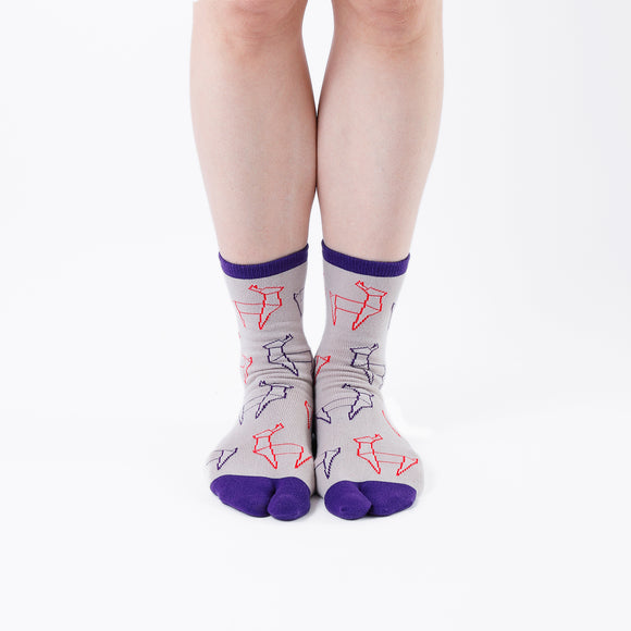Person wearing long beige Tabi Socks " Shika Origami ", front view