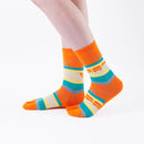 Person wearing long orange Tabi Socks " Densha ", right side view