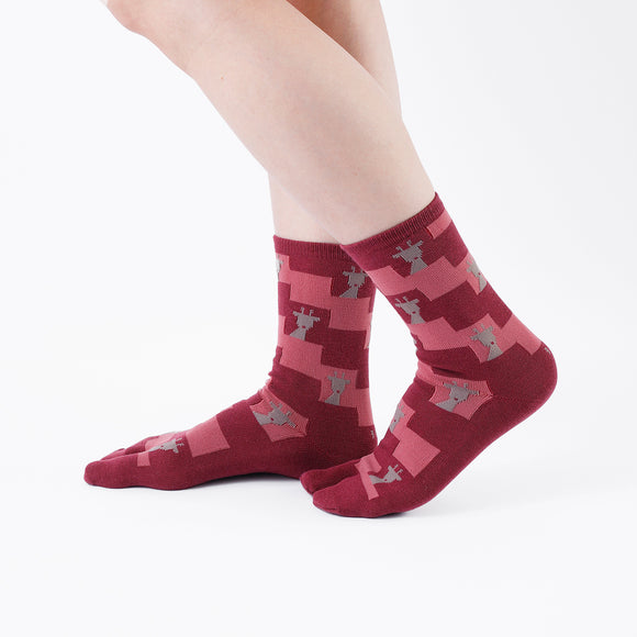 Person wearing long dark red Tabi Socks " Shika Nozoku ", right side view