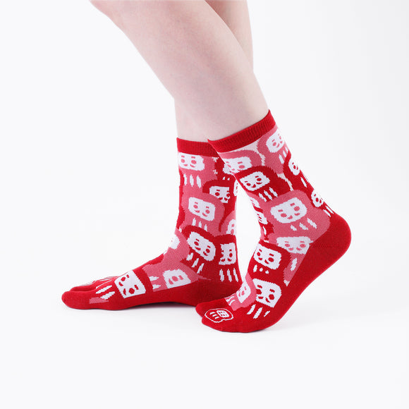 Person wearing long red Tabi Socks " Daruma ", right side view