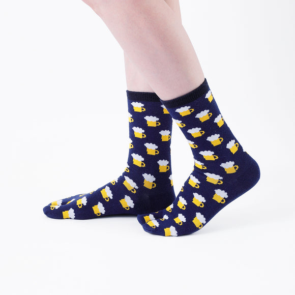 Person wearing long navy Tabi Socks " Beer ", right side view