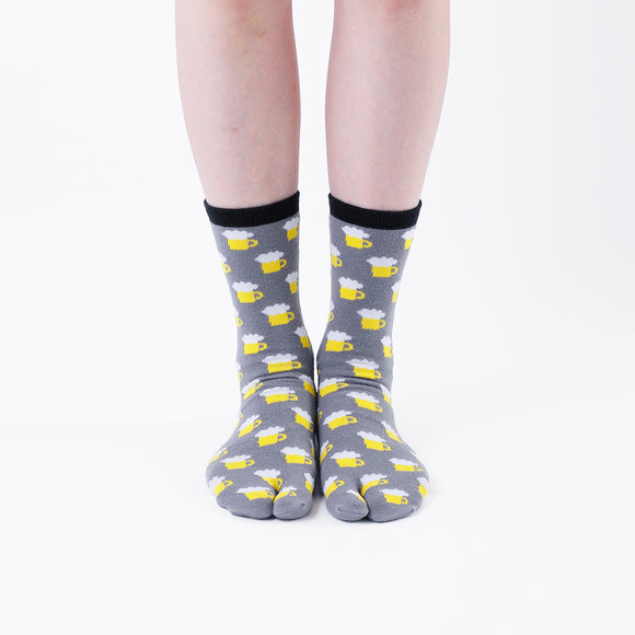 Person wearing long gray Tabi Socks " Beer ", front view