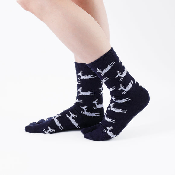 Person wearing long navy Tabi Socks " Shika Hashiru ", right side view
