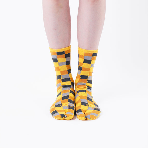 Person wearing long yellow Tabi Socks " Chigiri-e ", front view