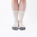 Person wearing beige Tabi Socks "NOBI NOBI", front view